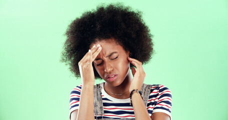 Green screen, headache and black woman on studio background with stress, migraine or pain....