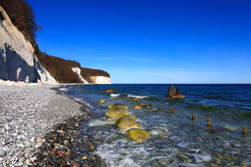 Scenic view of the Baltic Sea coast in Sassnitz, Germany with cliffs and pebbles.