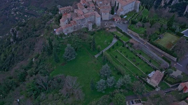 Aerial view of rustic architecture clinging to a cliff, Gourdon, France. Aerial drone video