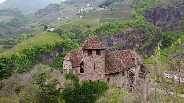Historic castle in green mountain valley, aerial for travel, history and nature concepts