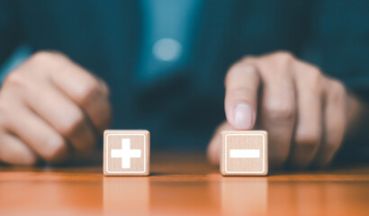 Businessman using marked with plus and minus symbols. Comparatively opposite concepts. analyze...
