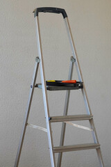 home renovation. staircase with bucket and roller ready to paint.