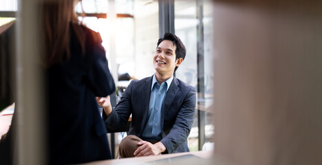 Fototapeta premium successful business partners coworking in office, young friendly businessman sharing idea with his colleague at meeting
