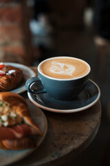 artisan coffee on a table in a cafe with baked goods