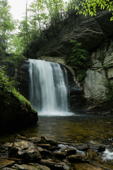 Obraz premium Looking Glass Falls viewed close-up with rocky stream in foreground