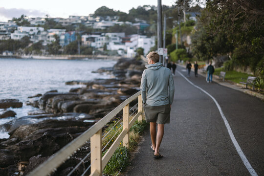 Man walking on manly beach promenade enjoying scenic views