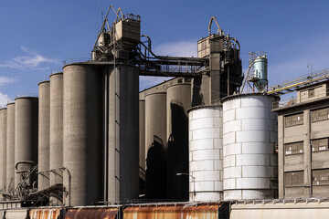 Industrial landscape concrete silos by train tracks © Cavan