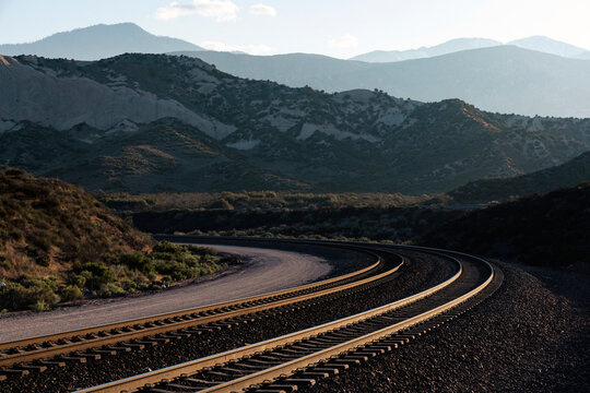 Curved train tracks in mountainous landscape
