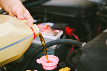 Fresh lube oil poured into car motor
