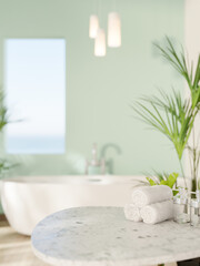 Marble stool table with towels and white ceramic bathtub near green mint wall with rectangular hole.