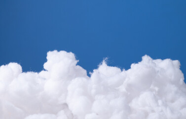 Siliconized hollowfiber, polyester fiber cloud held against a blue background
