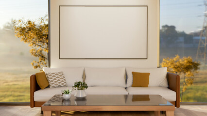 Blank frame on white wall between two glass doors of a living room with wooden table next to sofa.