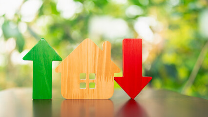 Image of house with up and down arrows. Concept of house prices. House construction prices and real estate prices can fluctuate and fluctuate. Risk control is important.