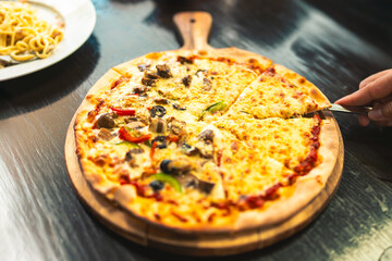 Freshly baked and ready to serve mini pizzas made in our kitchen every day. The concept of family dining together, family happiness with food.