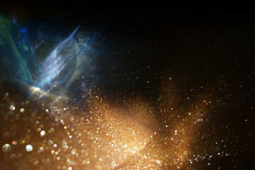 abstract glitter black and gold lights background. de-focused