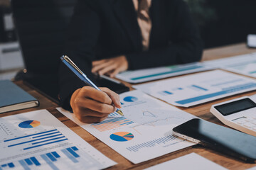 Group of business people brainstorming in analytical plan meeting Calculate the numbers obtained...