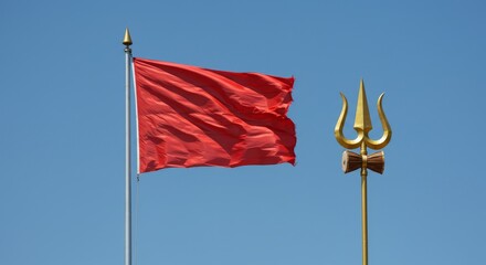 The red Murugan flag flutters beside the tall trident under the blue sky, top copy space.