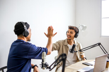 Two Podcasters Giving High Five to Each Other, Celebrating a Successful Recording Episode