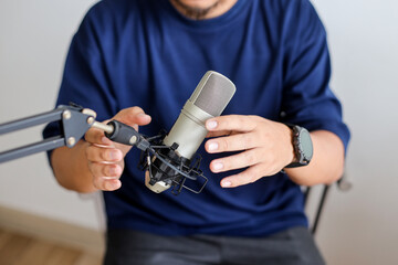 Podcaster Male Positioning Mic and Testing Audio Before Going Live.