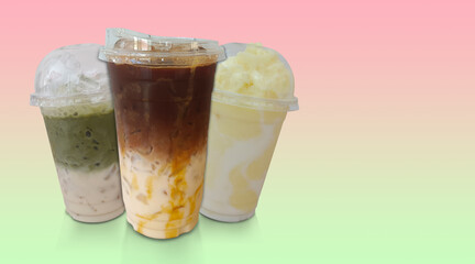 inside left, fresh caramel coffee and matcha green tea and pineapple smoothie in a plastic cups stacked, gradient pink and green background, drink, food, fashion, copy space