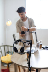 Male Podcaster Testing Microphone and Audio Settings Before Recording Session.