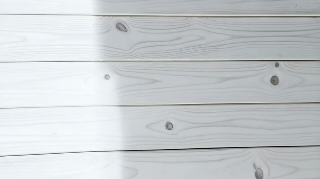 Bright white painted wood planks arranged horizontally with subtle grain details and a shadow, providing a clean background texture
