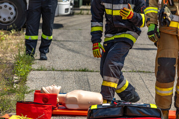 Fototapeta premium Mannequin pulled out of the wreckage of a crashed car by firefighters