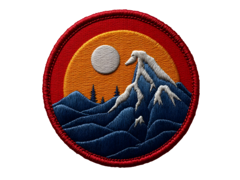 Circular embroidered patch with red border, blue mountains, orange sky, pine tree silhouettes and textured stitching PNG file isolated on transparent background
