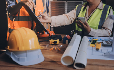 Engineers are helping to design work on blueprints and collaborate on structural analyzing of...