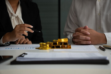 Businessmen discuss investing in gold bars and stocks