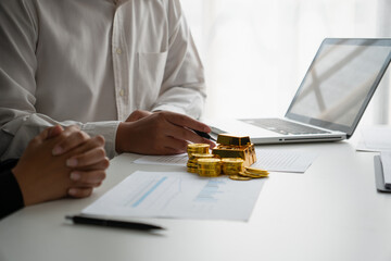 Businessmen discuss investing in gold bars and stocks
