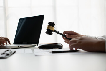 Lawyers meeting with legal counsel, holding lawyer's hammers