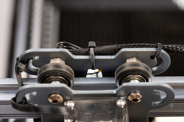 Close-up of linear guides and rollers in a CNC engraving machine.Detailed view of the axis motion...