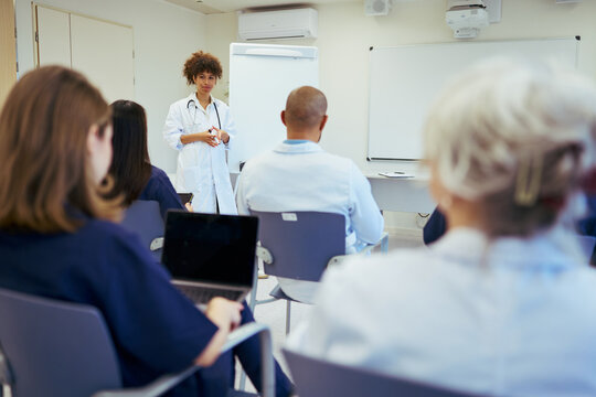 Medical team meeting: doctor leading training session for healthcare professionals
