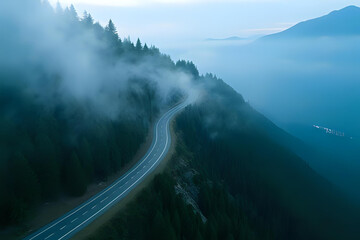 Aerial view of a scenic route with sharp turns surrounded by tall evergreens - Drone shot over a winding mountain road cutting through dense pine forest