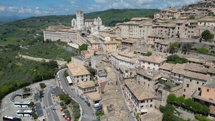 Fototapeta premium EUROPE, ITALY ASSISI 06,04,2025 The Basilica of Saint Francis San Francesco in Assisi, Umbria.Drone aerial view of Papal Patriarchal Basilica of Saint Francis and the historic city with tiled roofs