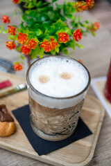 Latte Macchiato in a Glass on a Wooden Tray, A glass of latte macchiato served on a rustic wooden tray, glasses of latte macchiato