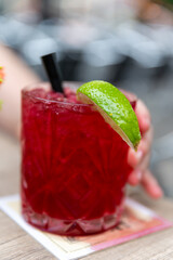 glass of fresh lemonade,Glass with red wrapper on wooden table. Static shot in contemplation,...