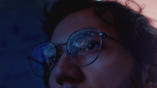 A man with glasses is looking at an MRI monitor, the result of research. The male sees a 3D model of the brain, a VR image. Studying the neural network inside the human body