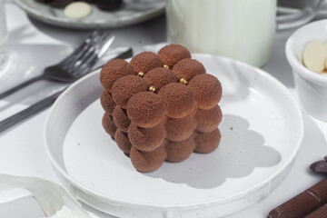 Mousse cake . Beautiful cake covered with Velour  in a plate on the table. Confectionery, coffee shop