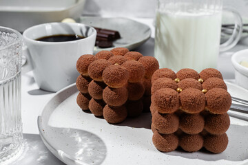 Mousse cake . Beautiful cake covered with Velour  in a plate on the table. Confectionery, coffee shop