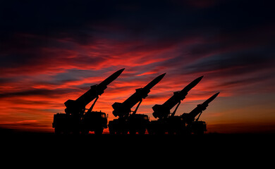 Military missile launchers silhouetted at dusk with vivid red and purple skies, highlighting themes of warfare, conflict, and preparedness.