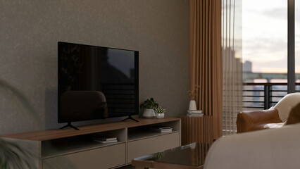 TV placing on wooden table beside balcony door in front of leather sofa in a living room or bedroom.