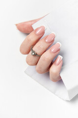 Woman hand showing french manicure and elegant ring on white background