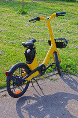 The electric bike at the rental company is in the parking lot.