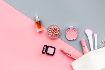 Layout of cosmetic bag with makeup brown pink shade beauty products, top view