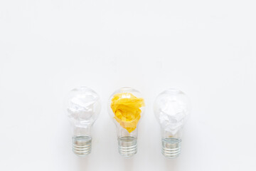 Yellow paper in light bulb, top view. Education concept. Creative idea and business innovation