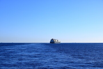 container ships on Strait of Gibraltar with morocco mountains in background