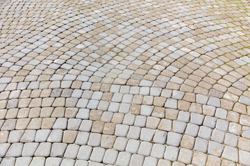 A gray and white brick patterned walkway