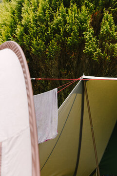 Detail of two tents with lines in between them and a towel.